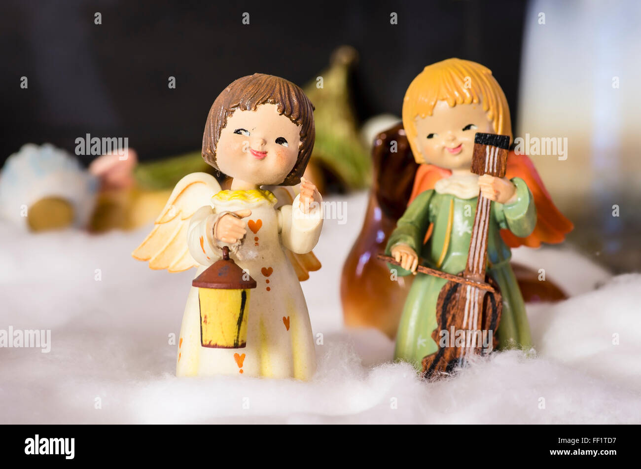 Christmas decorations featuring small angels making music in the snow in an English home in Uk Stock Photo
