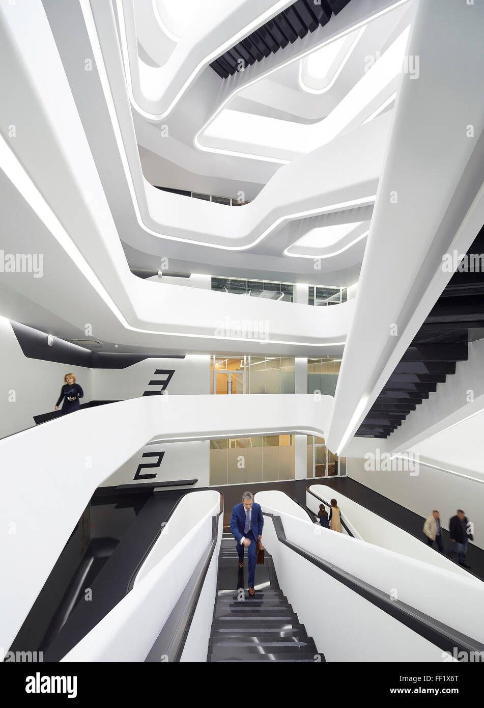 Central atrium with skylight and projecting balconies and interconnecting staircases. Dominion Tower, Moscow, Moscow, Russia. Ar Stock Photo