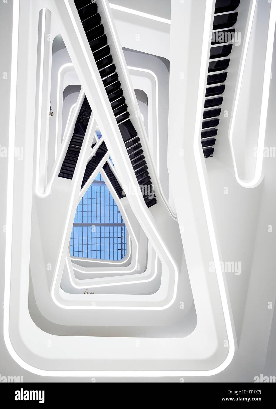 Atrium with projecting balconies and staircases viewed from below. Dominion Tower, Moscow, Moscow, Russia. Architect: Zaha Hadid Stock Photo