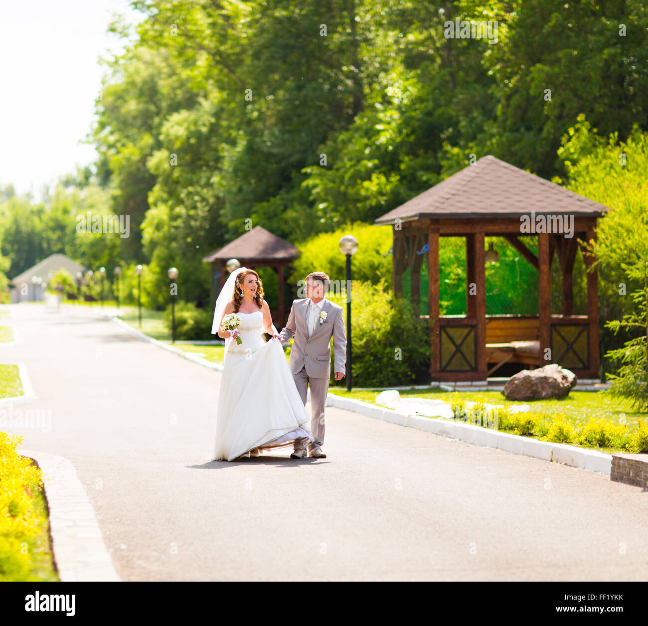 Bride and groom holding hands outdoors Stock Photo - Alamy