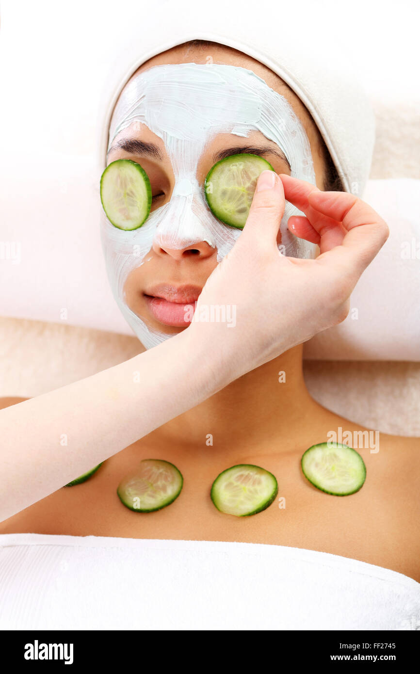 Green clay, natural cosmetics, cleansing and toning the skin. Woman in a beauty salon, Green mask, woman in spa salon Stock Photo