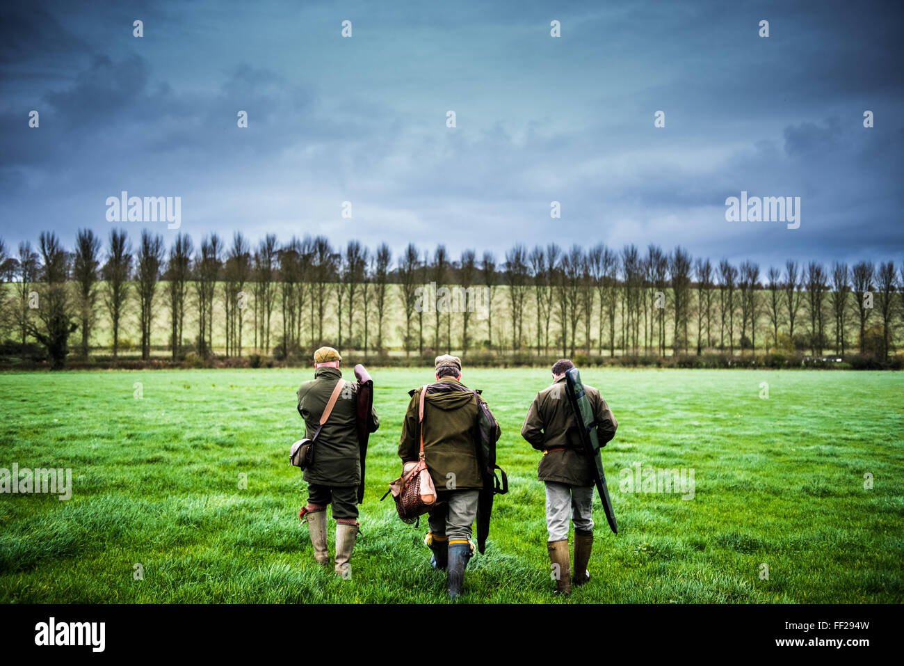 Three guns walking towards a drive, Wiltshire, England, United Kingdom, Europe Stock Photo