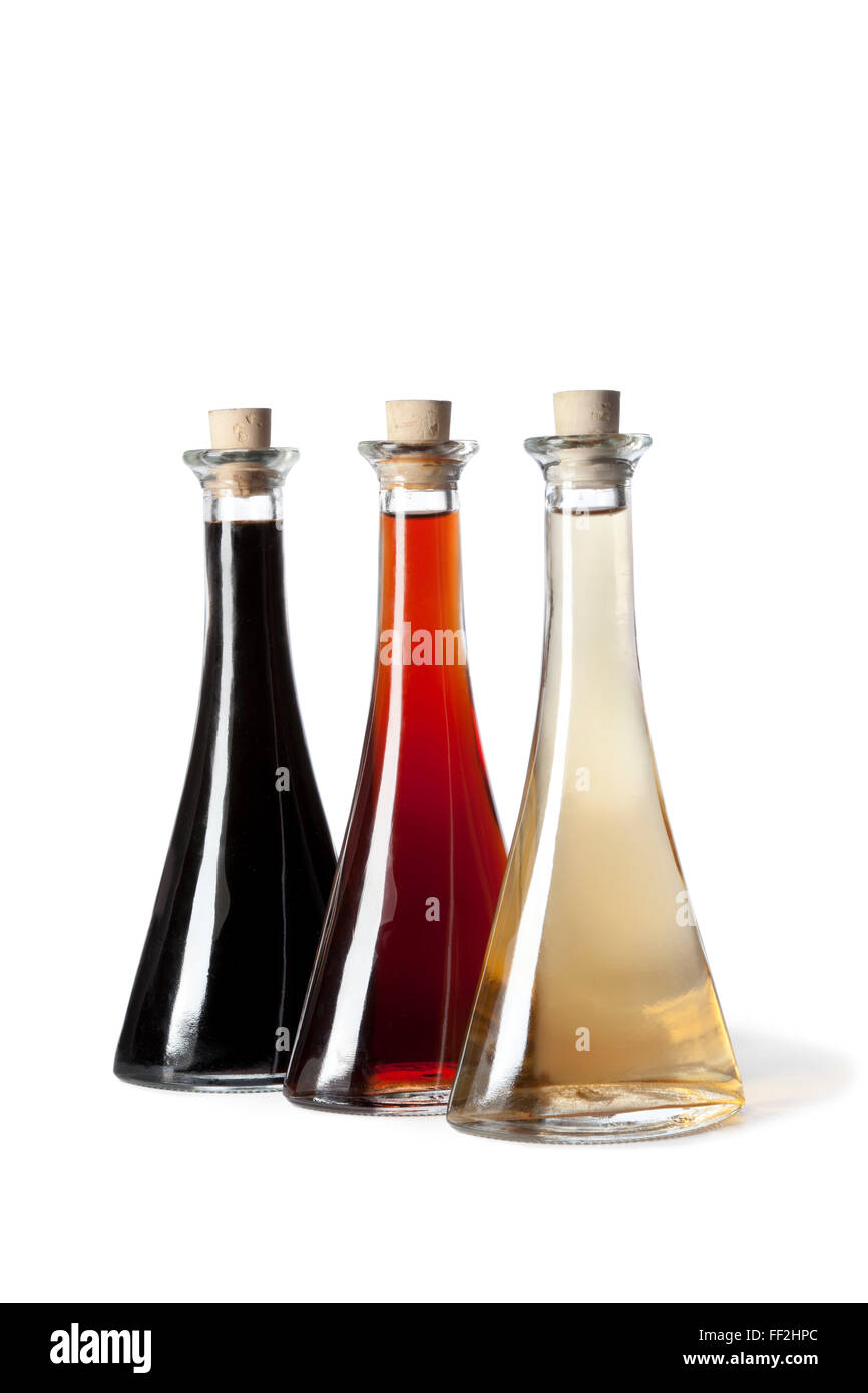 Three bottles with different type of vinegar on white background Stock Photo