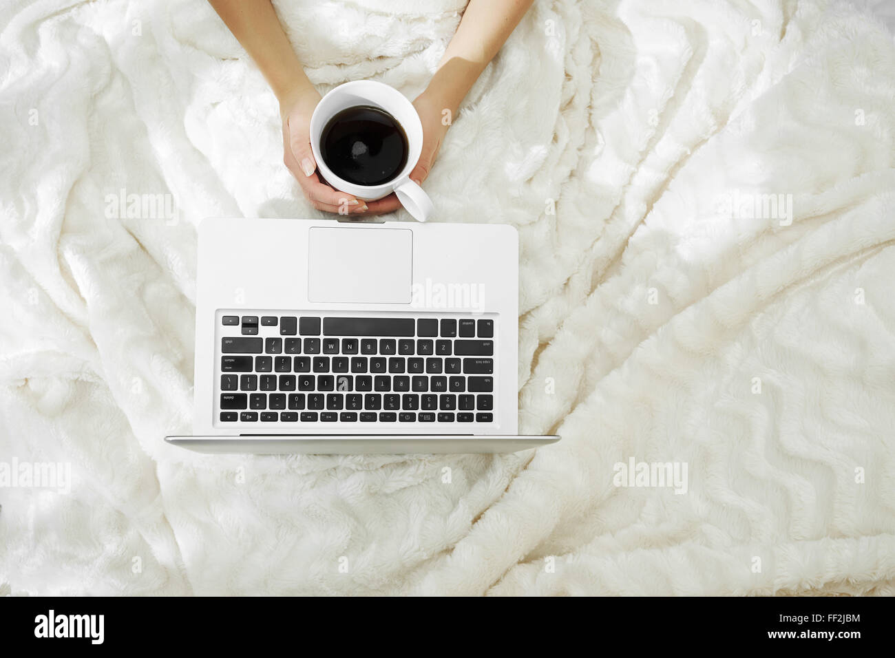 Woman hands holding a cup of hot coffee in bed Stock Photo - Alamy