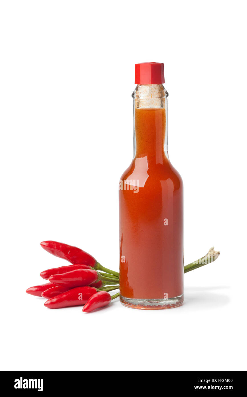 Bottle with hot chili pepper sauce and fresh tabasco peppers on white background Stock Photo