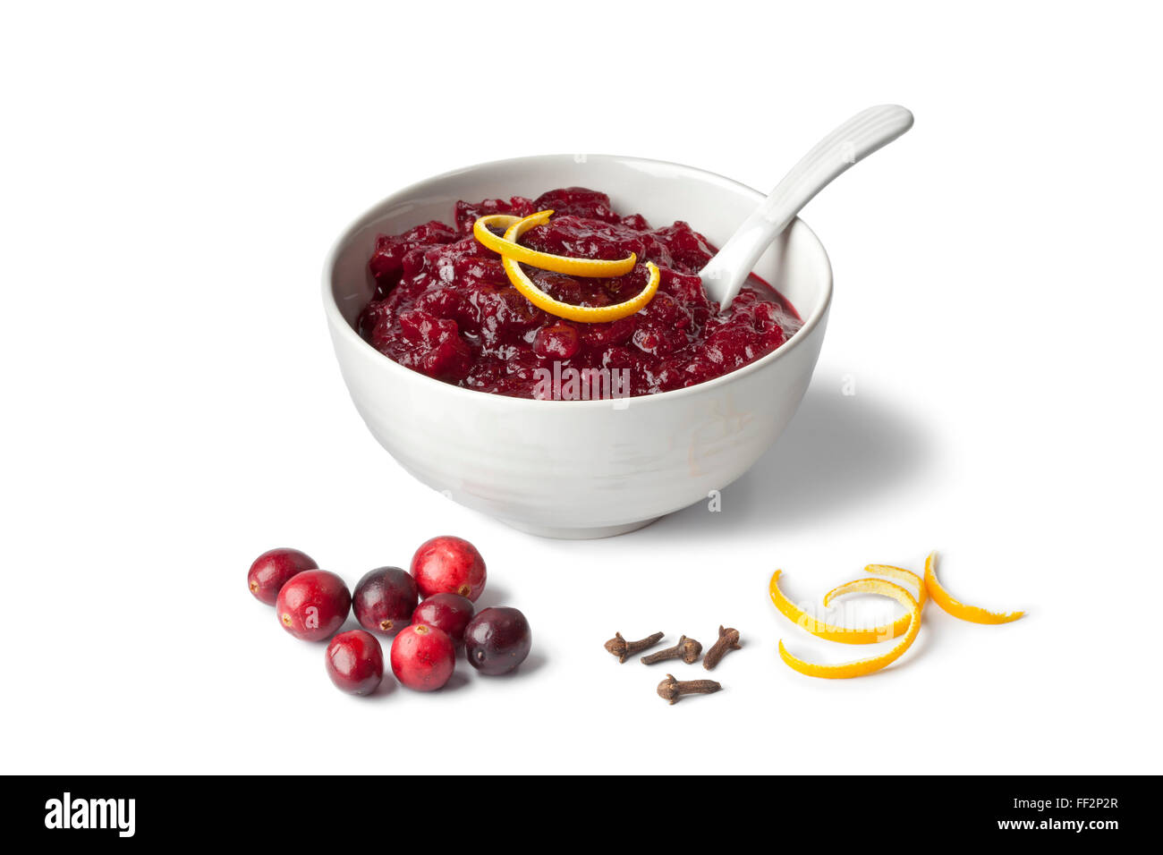 Fresh cranberry sauce with orange peel and cloves on white background Stock Photo