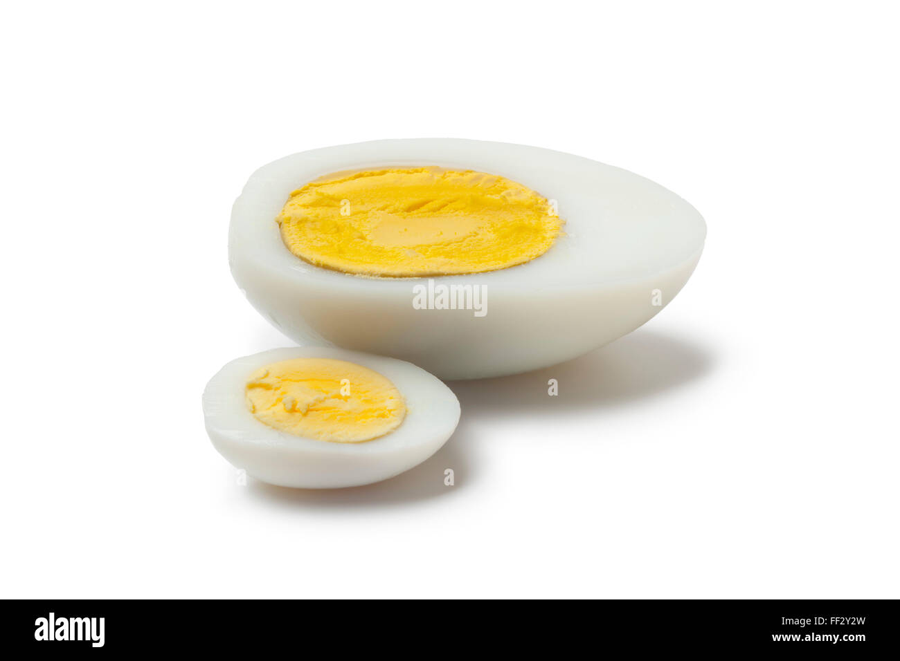 Cooked chicken and goose egg cut in half on white background Stock Photo