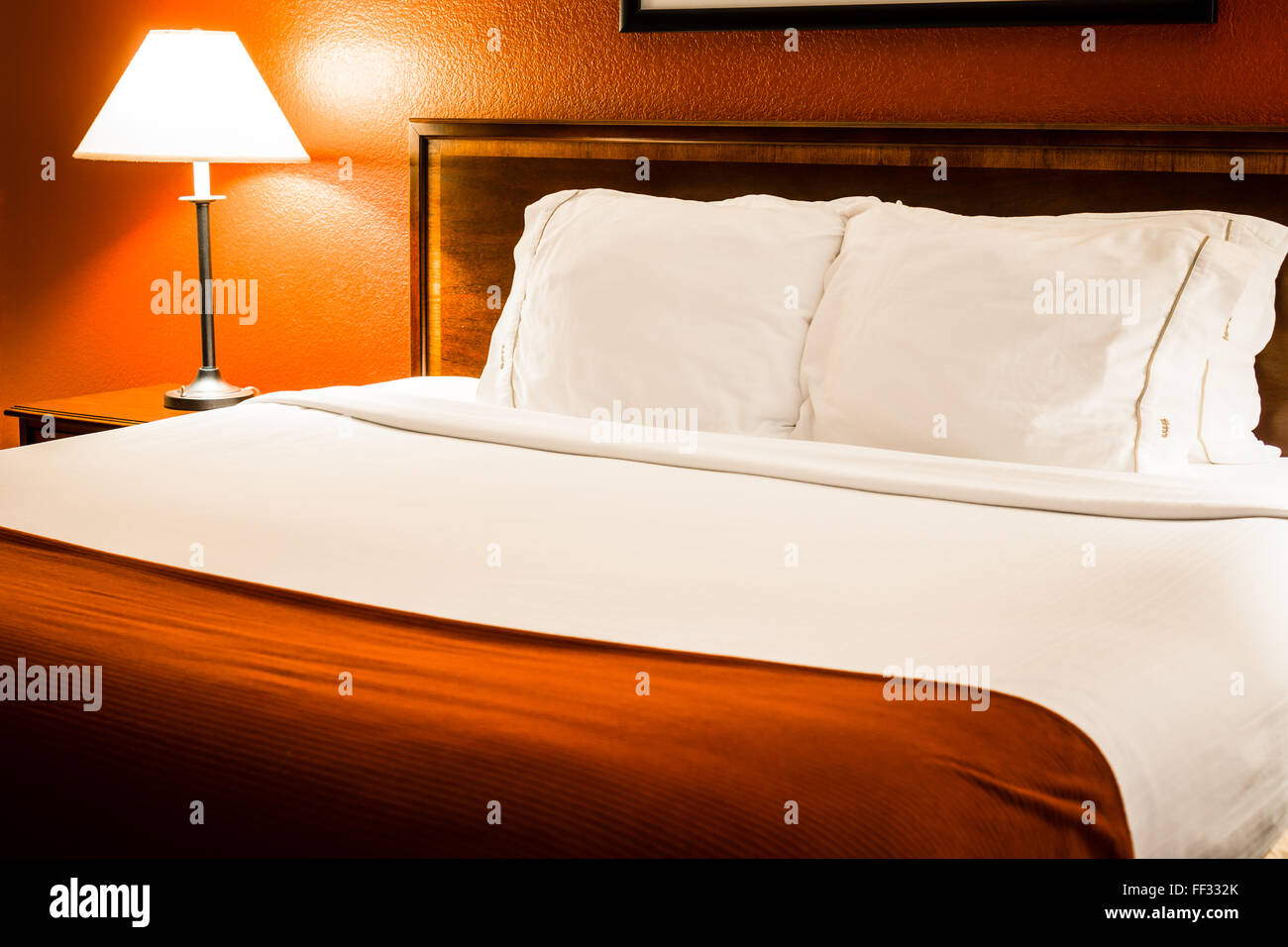 Picture Of Hotel Room Bed And Pillows With Red Wall And