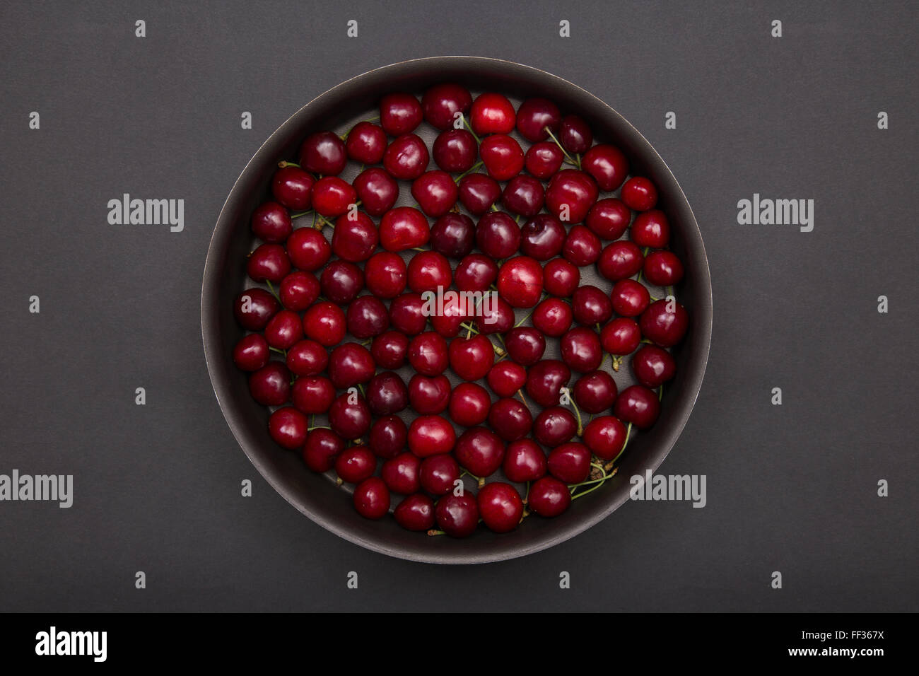 Top view of red cherries in round baking tin Stock Photo