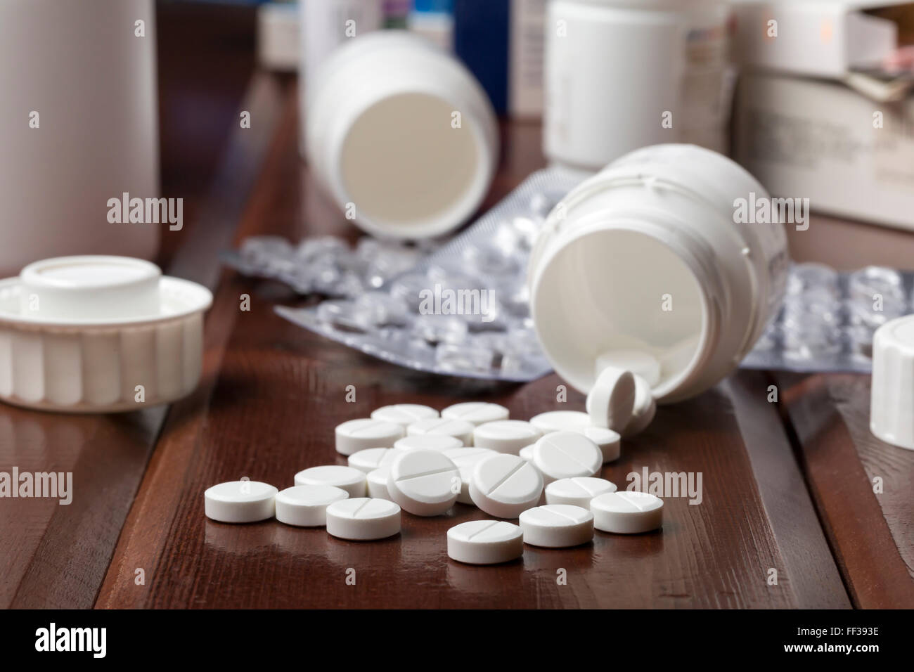 White pills and empty pill bottles Stock Photo