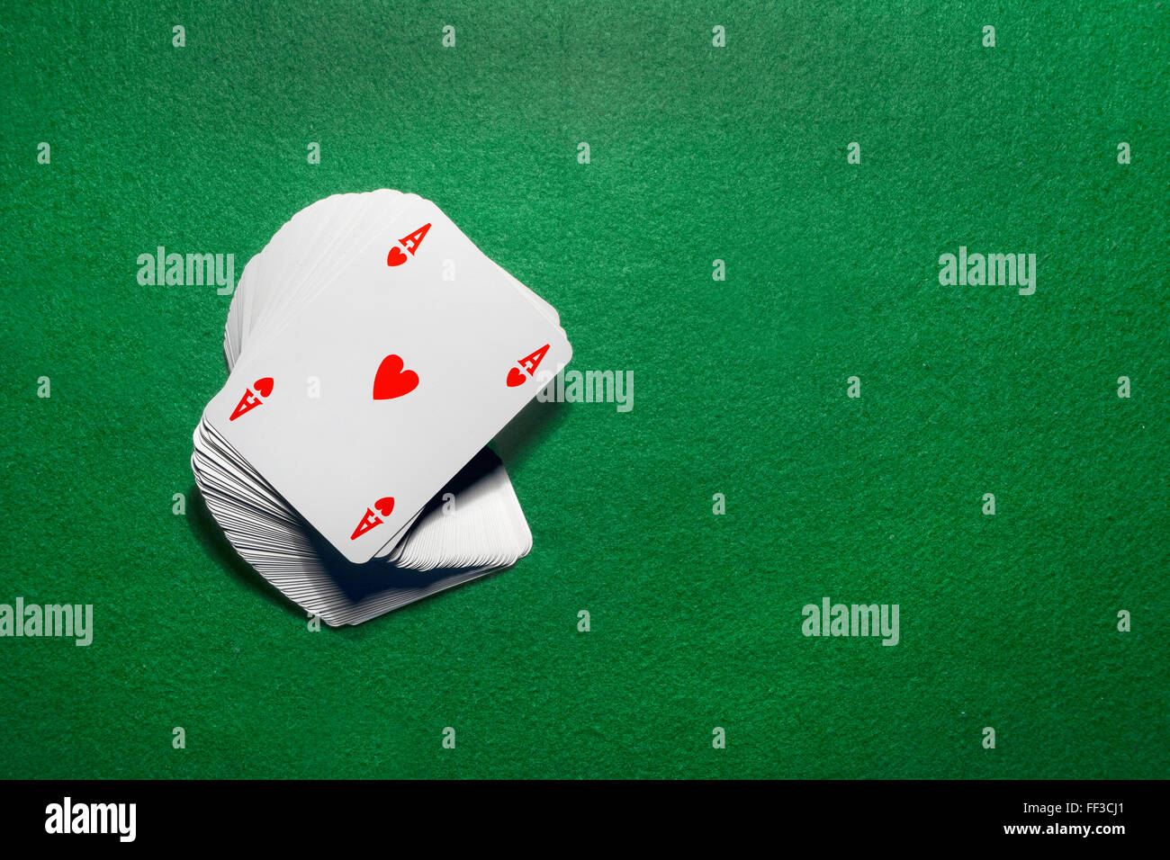 Playing cards isolated on green background Stock Photo