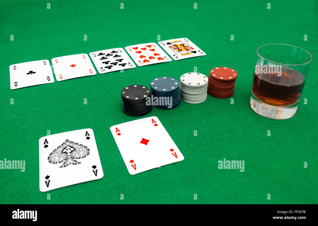 Playing cards isolated on green background, four ases Stock Photo