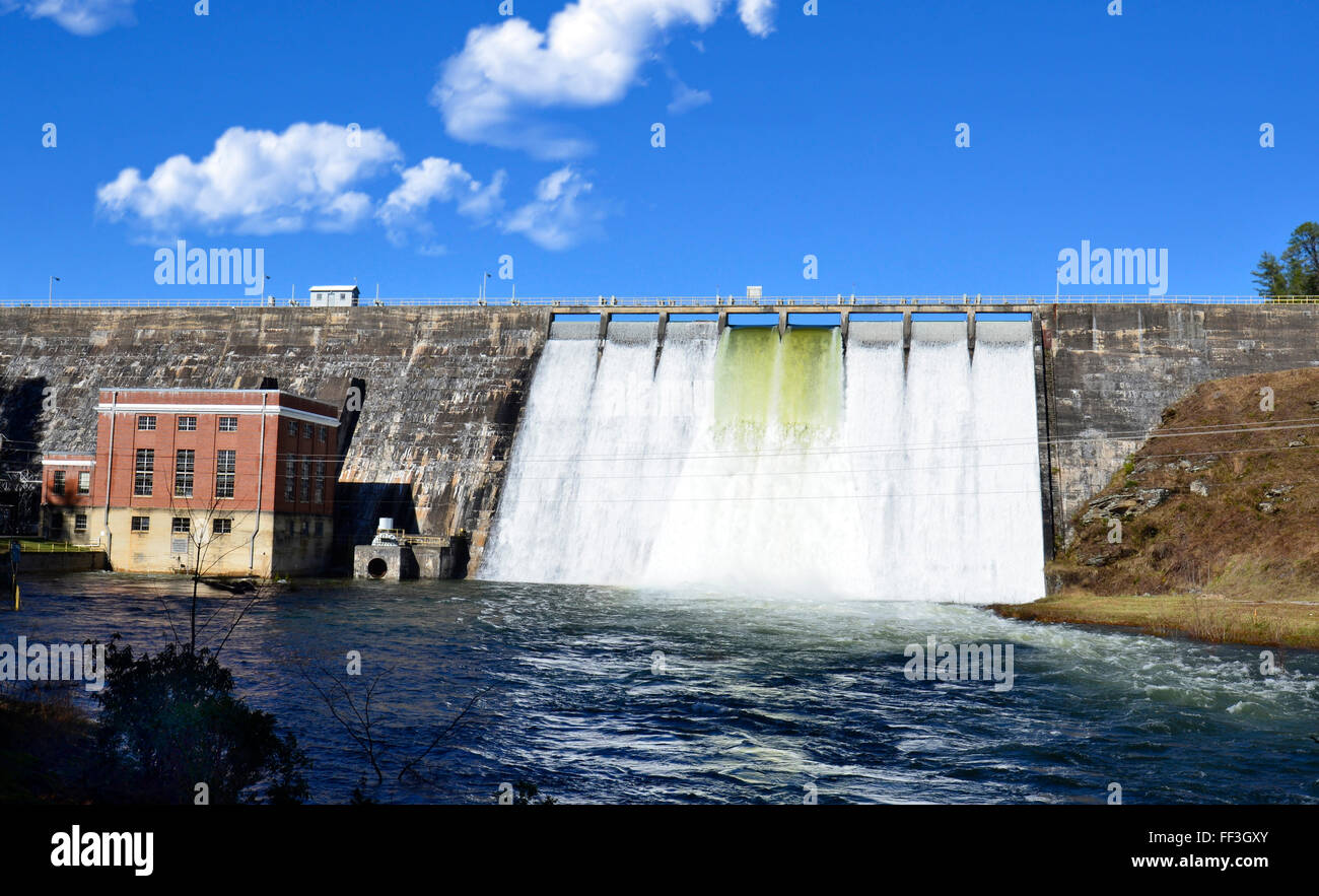 Water flowing through the gates of a dam after a storm. Stock Photo