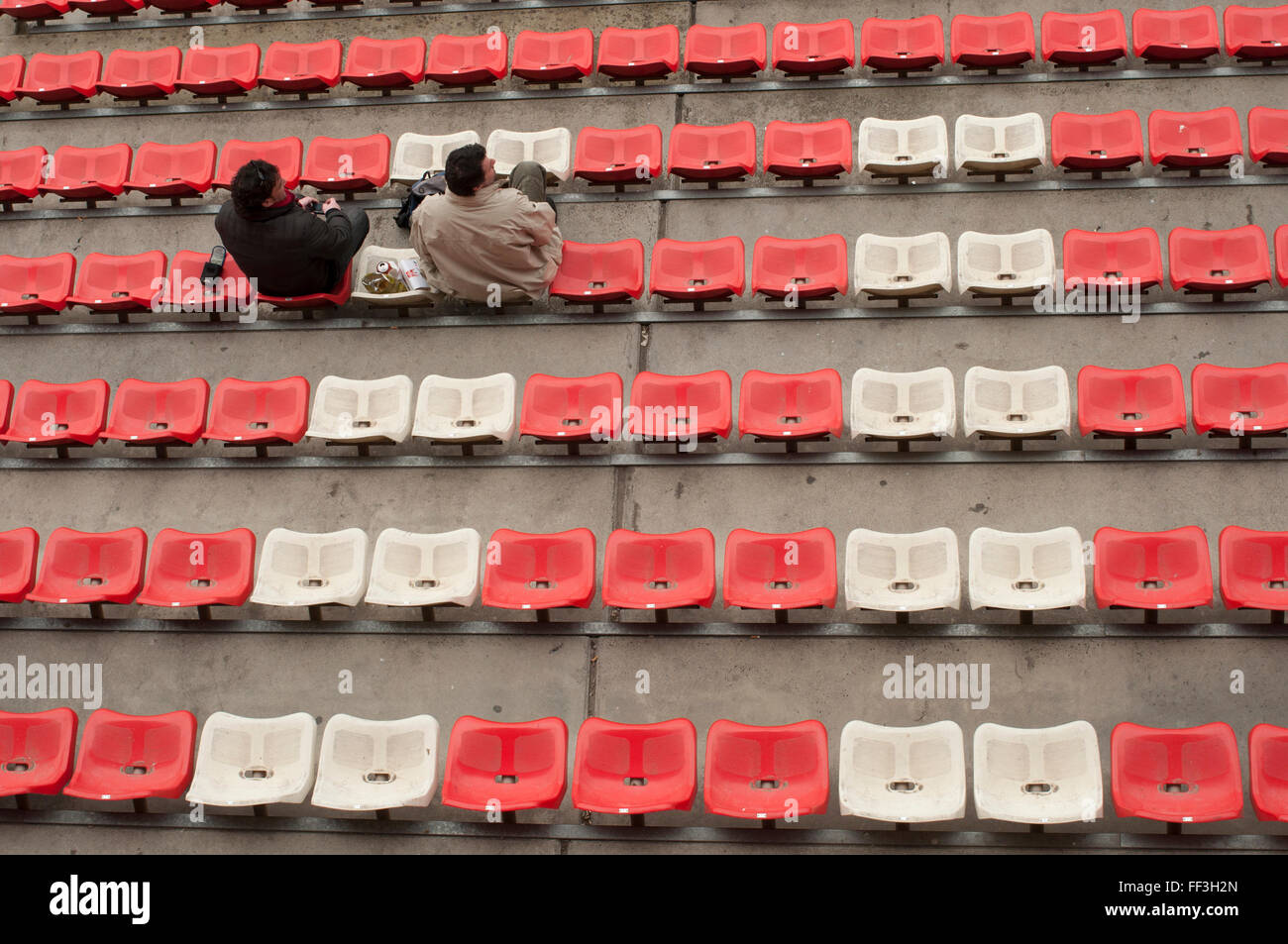 Couple in a Formula1 grandstand seats. Stock Photo