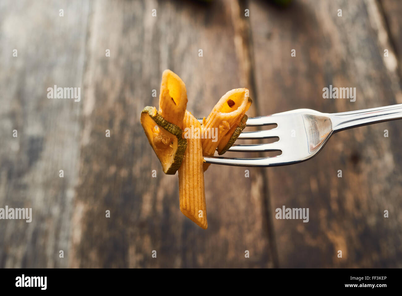Whole wheat pasta with zucchini taken with fork Stock Photo