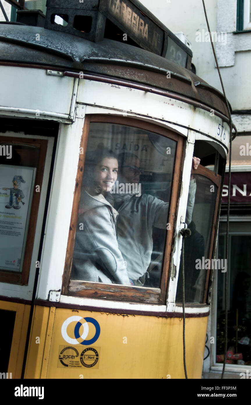 Pretty girl in a yellow tram in Lisbon Stock Photo