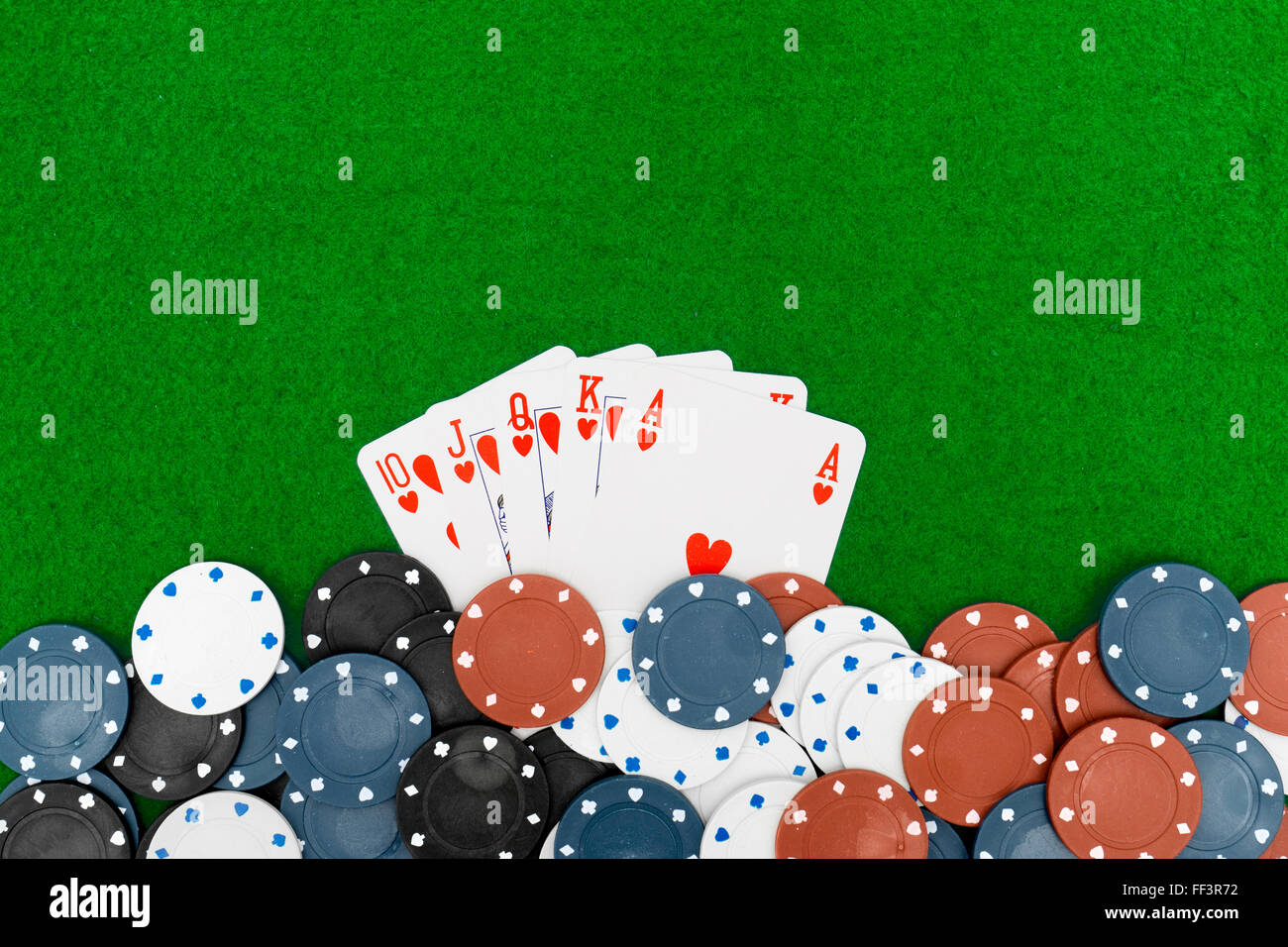 Playing cards isolated on green background, Royal Flush Stock Photo