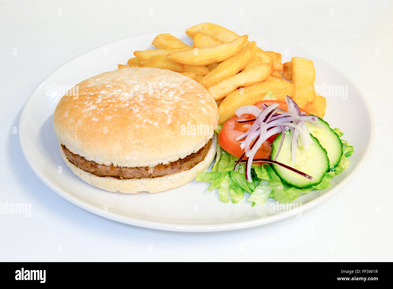 Meat burger meal in a bun with chips and salad Stock Photo