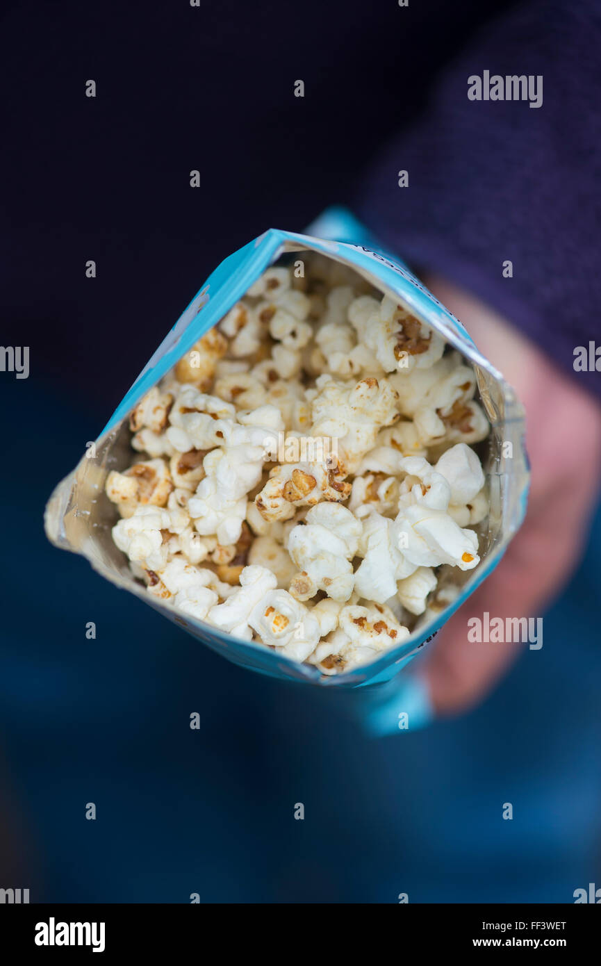 Hand holding an packet of Propercorn flavored popcorn Stock Photo Alamy