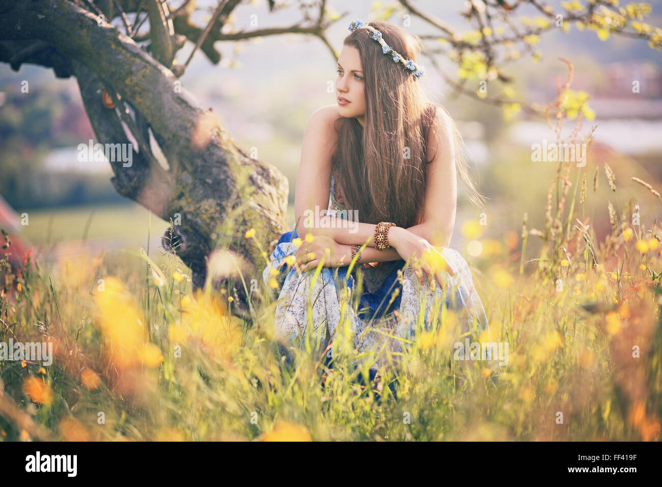 Beautiful hippie woman with summer flowers. Peace and harmony Stock Photo