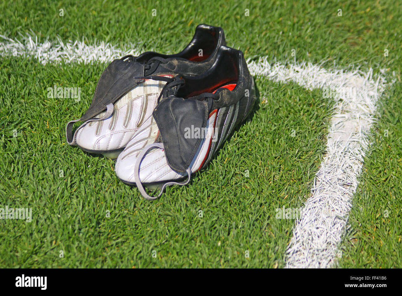 Pair of football boots on the grass Stock Photo Alamy