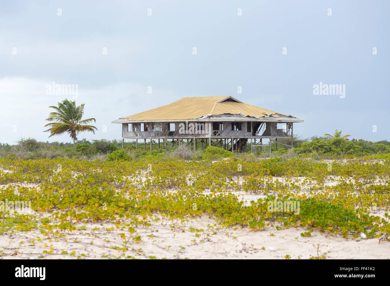 Derelict wooden building on stilts on a beach in south Barbuda, Antigua and Barbuda, West Indies Stock Photo