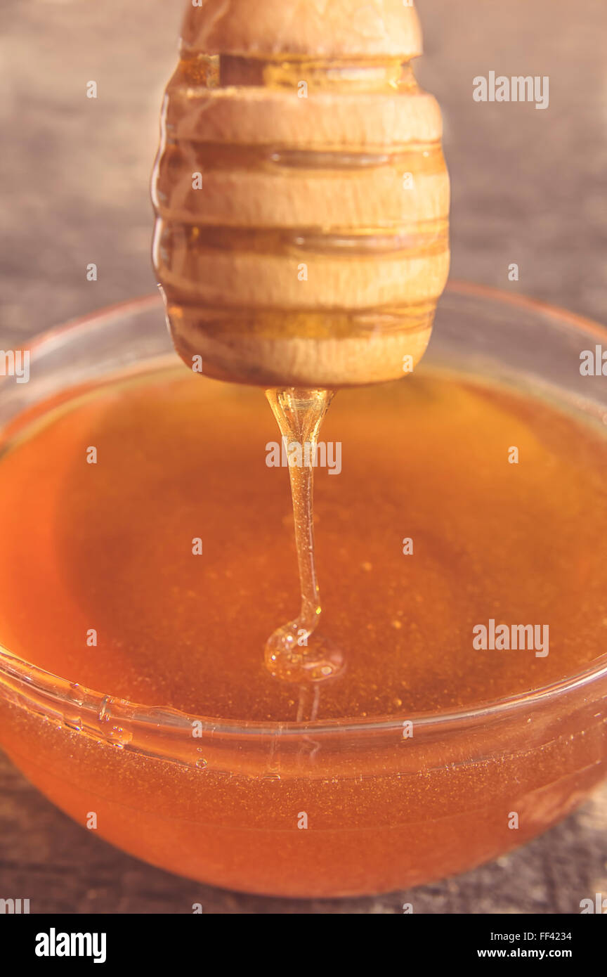 Bee honey with wooden dipper. Selective focus Stock Photo Alamy