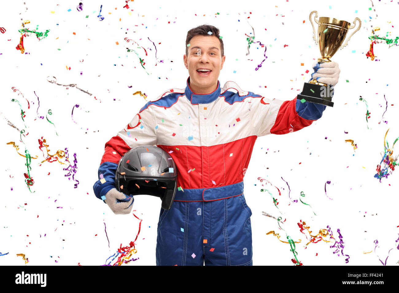 Joyful car racer holding a gold trophy and celebrating with confetti ...