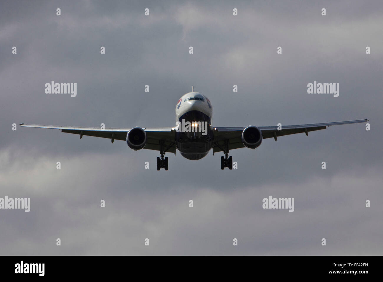 A British Airways Boeing 777 landing at Heathrow airports north runway. Stock Photo