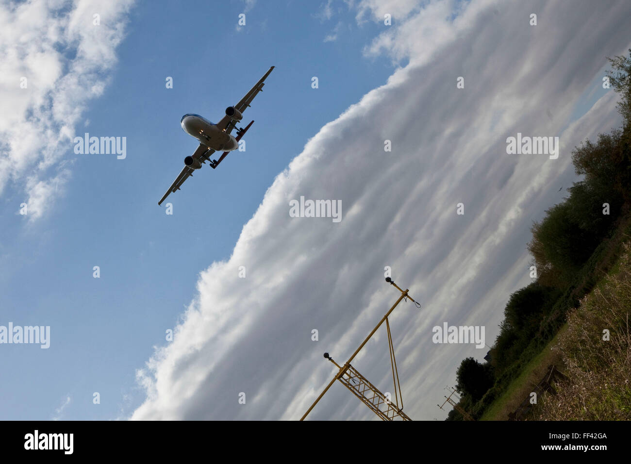 An aeroplane landing at London Heathrow airports north runway. Stock Photo