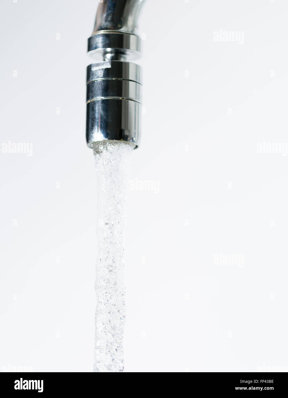 Water Pouring from Water Faucet close up. Stock Photo