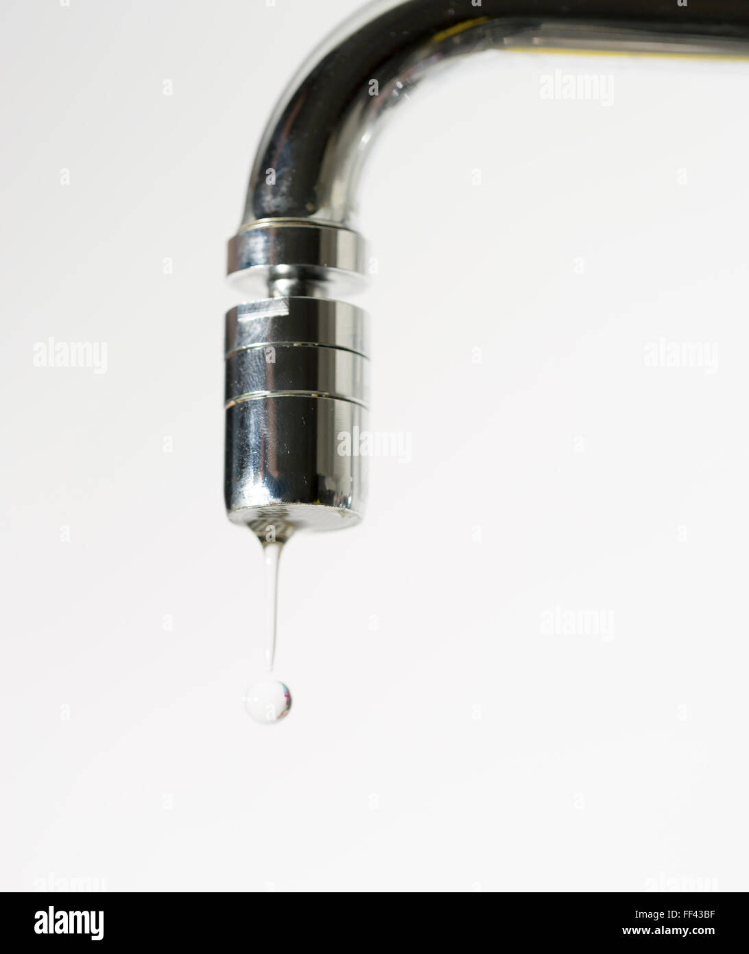 Water Dropping from Water Faucet close up. Stock Photo