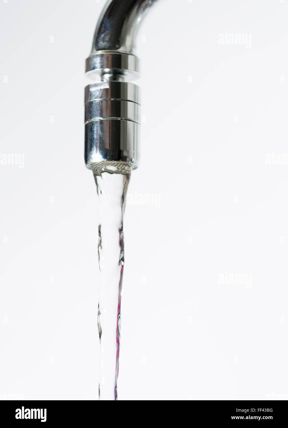 Water Pouring from Water Faucet close up. Stock Photo
