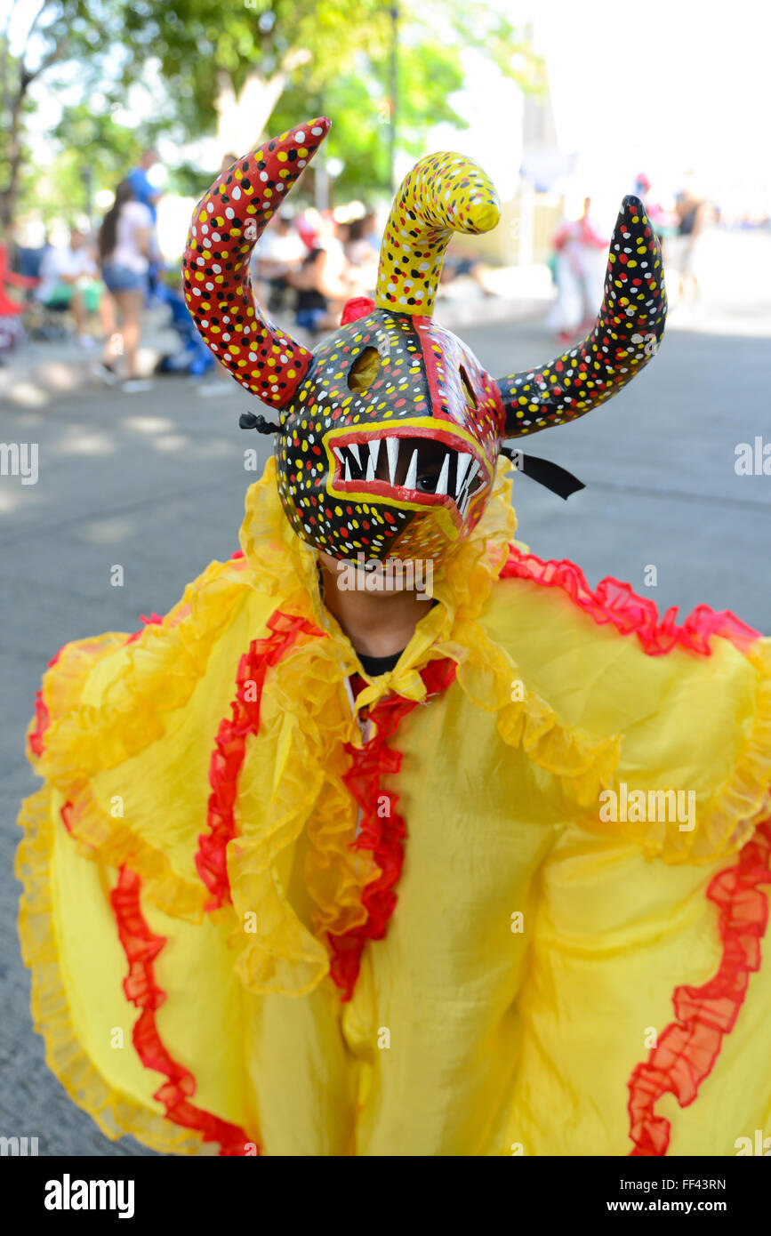 A child dressed as the masked figure VEJIGANTE posing during carnival in Ponce. Puerto Rico. US territory. February 2016 Stock Photo