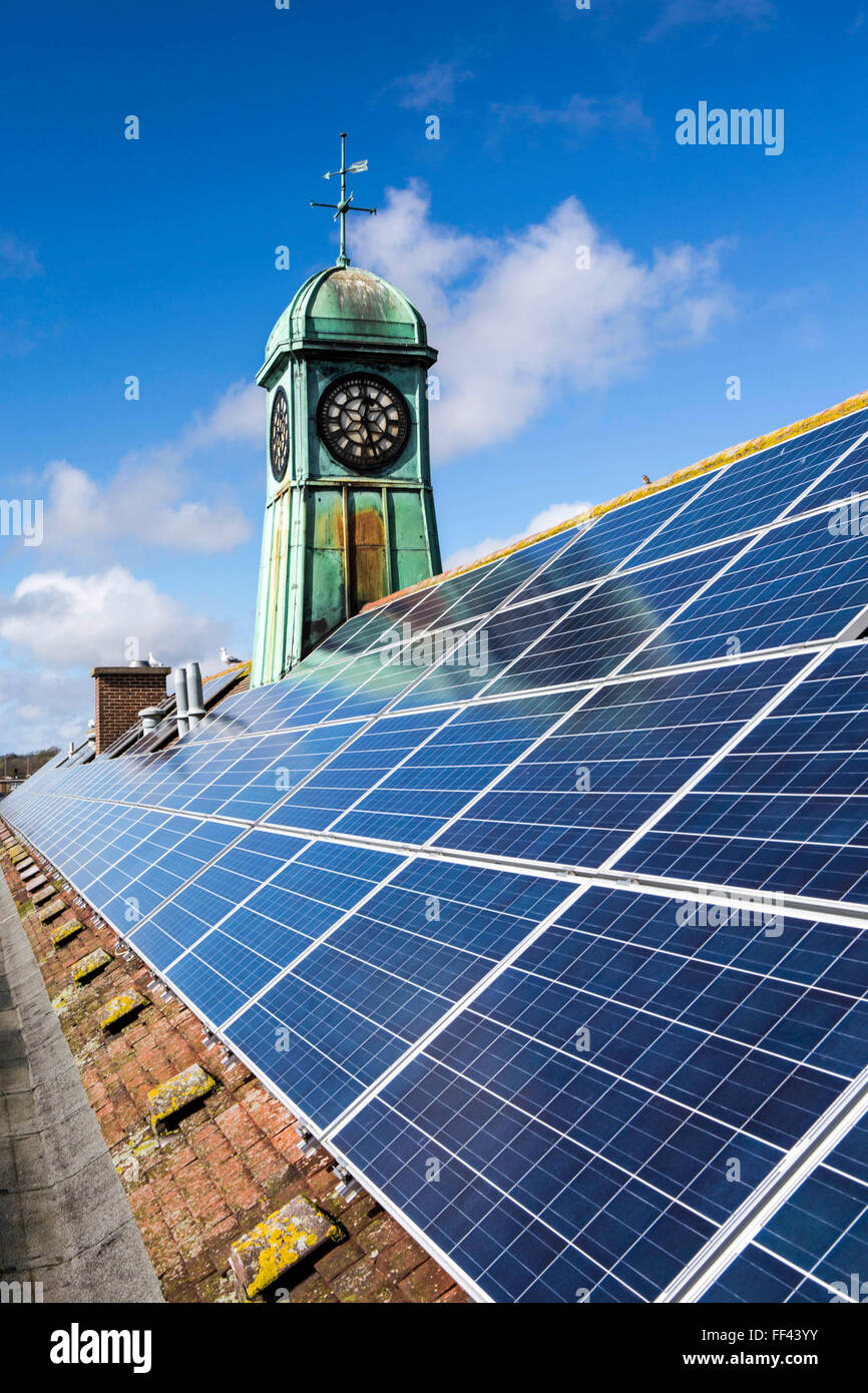 Solar PV Photo Voltaic panels on the roof of the Priory school in Lewes, East Sussex. Set up by  OVESCo community  investors. This panel, or module, is made up of photovoltaic (PV) cells. PV cells convert sunlight into electrical energy. Stock Photo