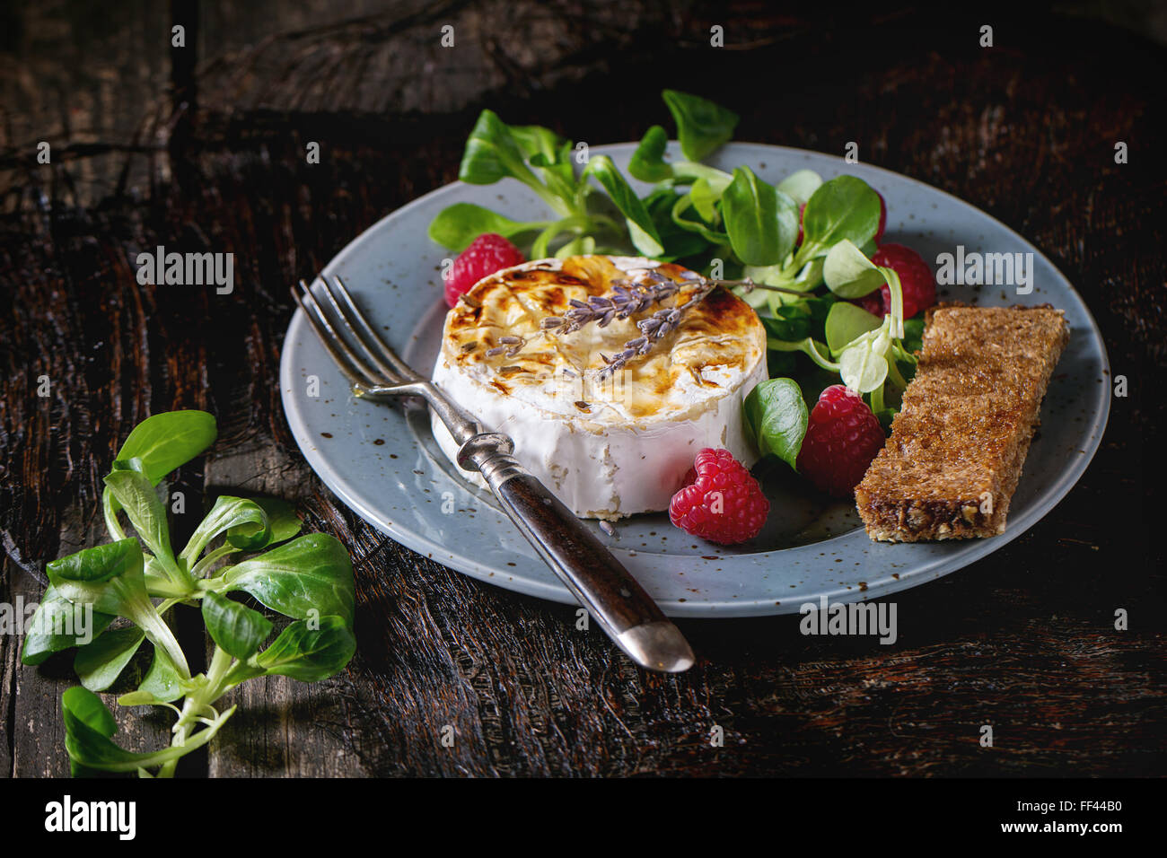Baked Goat cheese with honey and raspberries Stock Photo Alamy