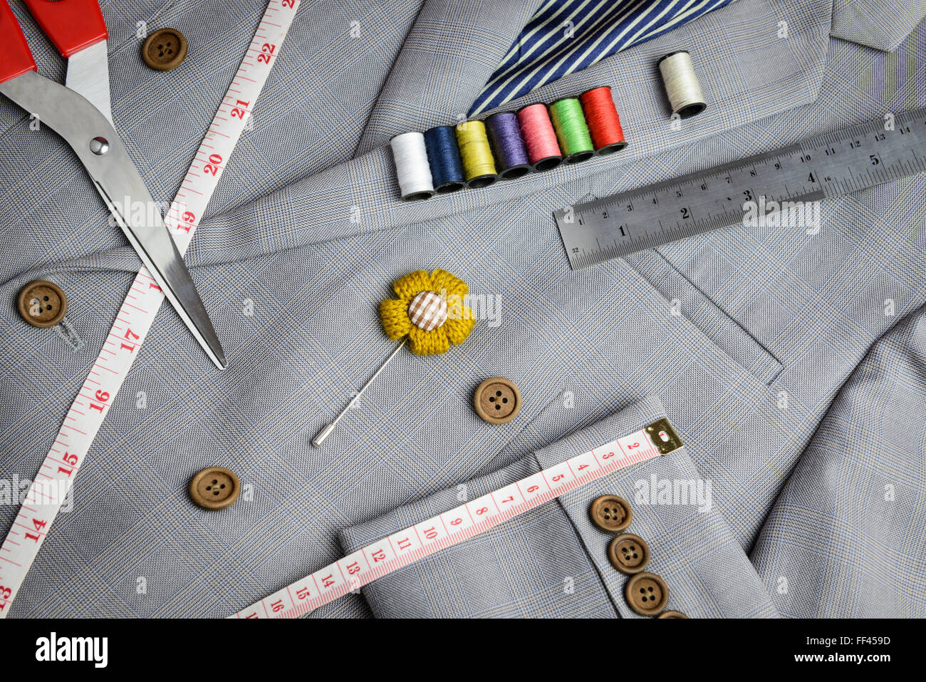 cutting, tailored equipments on double breasted suit, measurement tape, scissors, thread coil Stock Photo