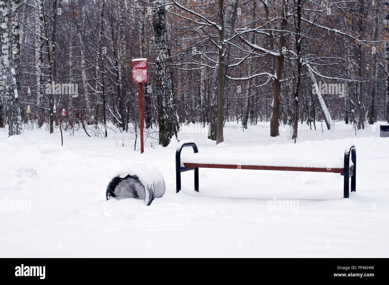 Bench and trashcan with a lot of snow Stock Photo