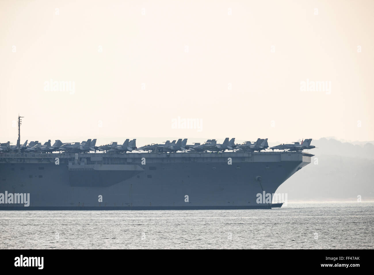 The Nimitz class aircraft carrier USS Theodore Roosevelt , at anchor in Stokes Bay in the Solent, 25th March 2015. Stock Photo