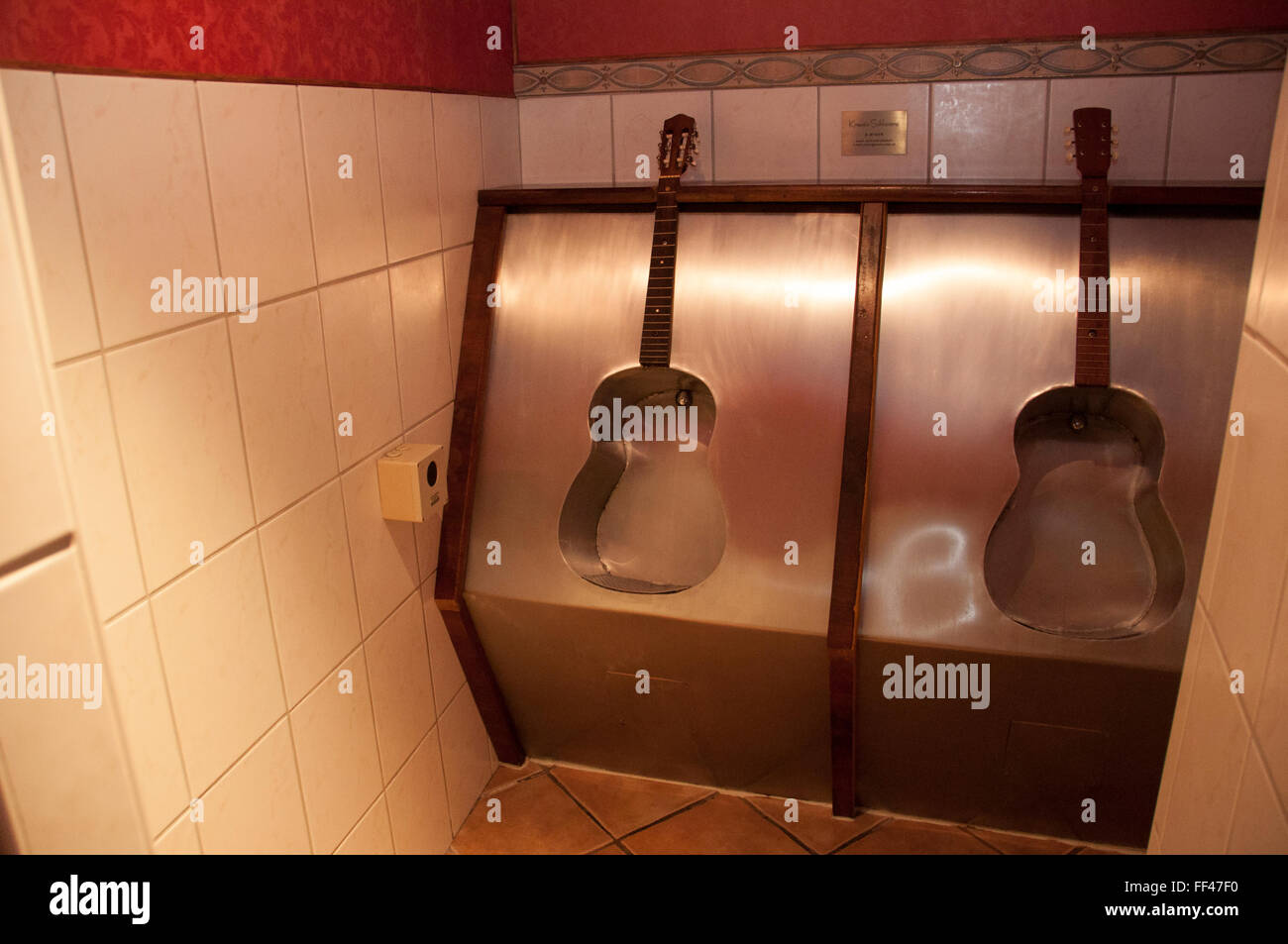 toilet in the restaurant 'Goldener Löwe' at Hall in Tirol, Austria in form of guitars Stock Photo
