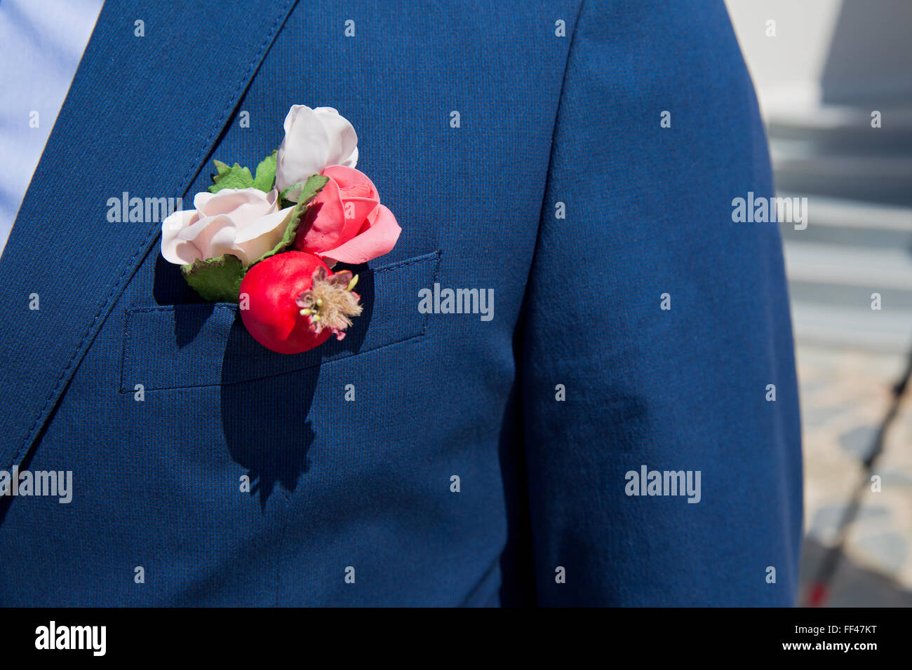 Boutonniere flower on jacket of wedding groom Stock Photo
