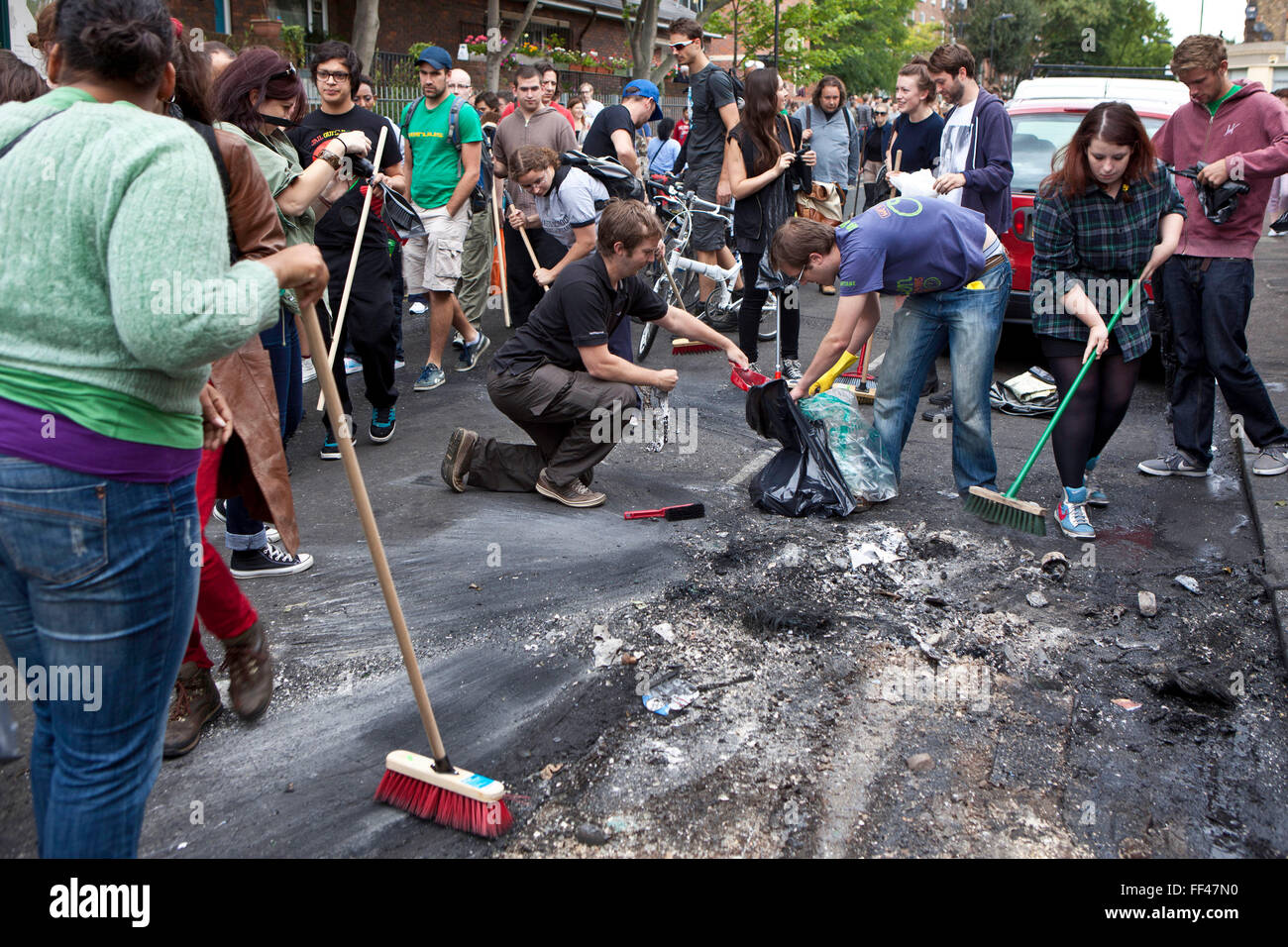 Hackney Riot Bus Hackney residents clean up debris from the riot after burnt out ...