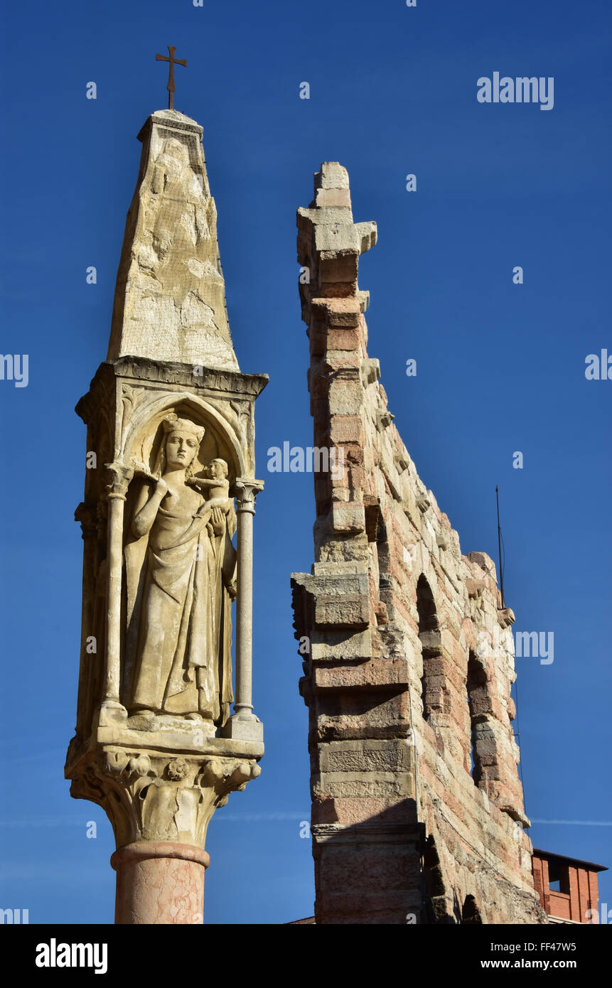 Christian shrine with Mary and Verona Arena outer ring in the background, in the center of Verona Stock Photo