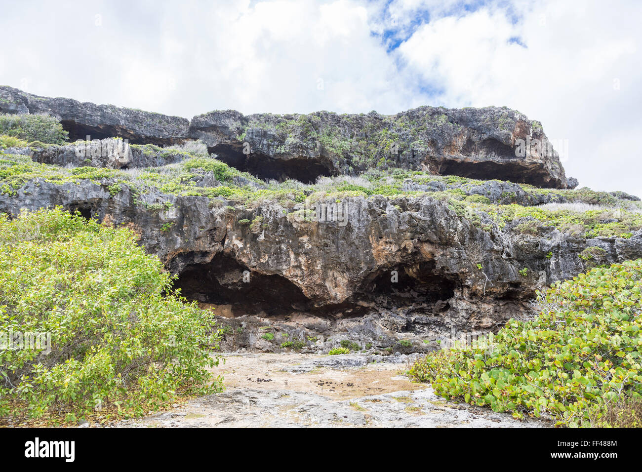 Coastal landscape and scenery: caves and rocky terrain by the coastline ...