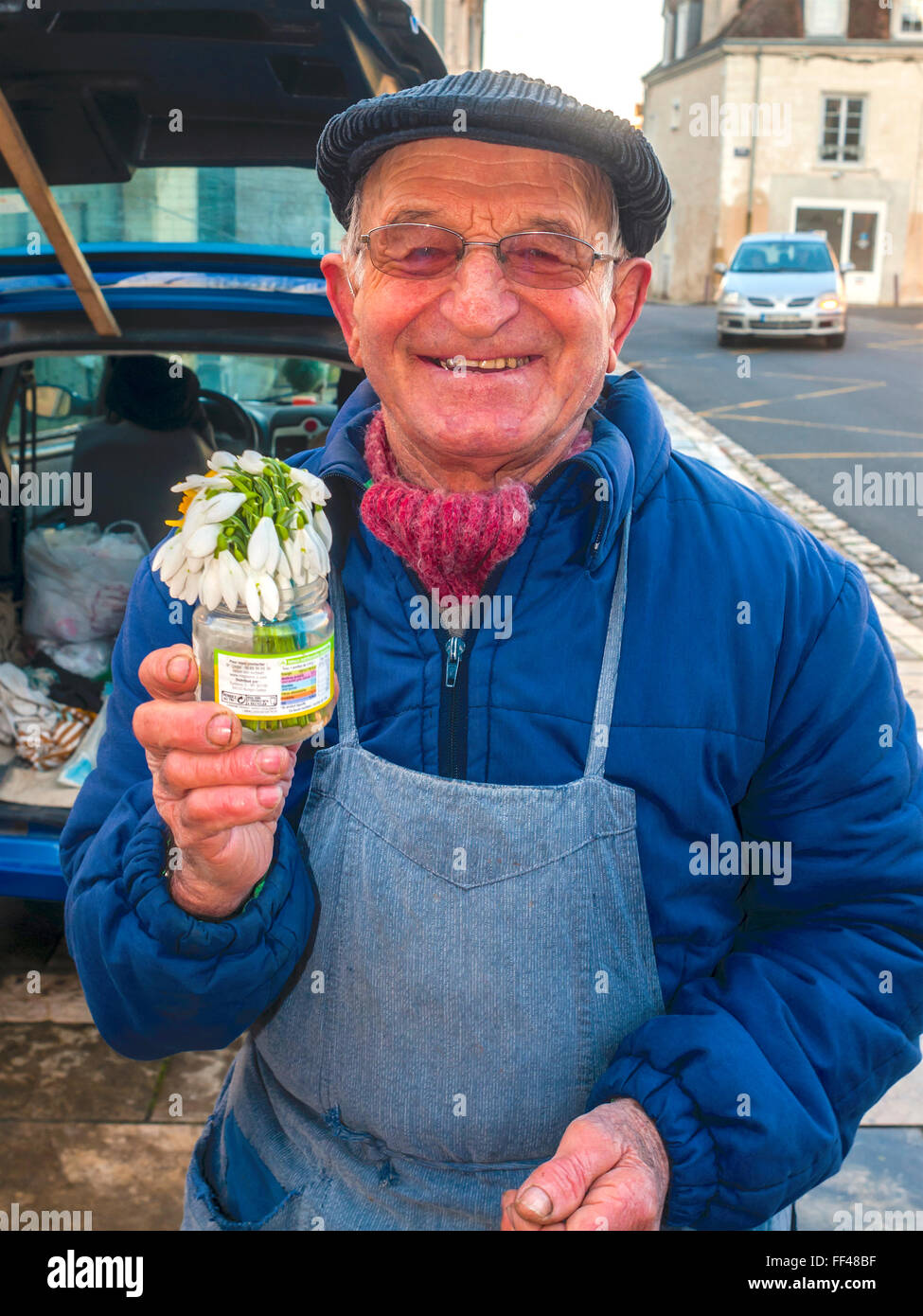 Market trader with bunch of Snowdrops - France. Stock Photo