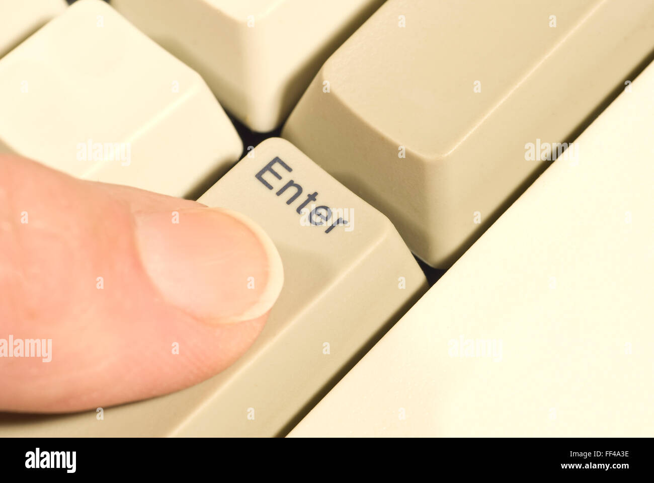 Finger Pressing ENTER Key Stock Photo