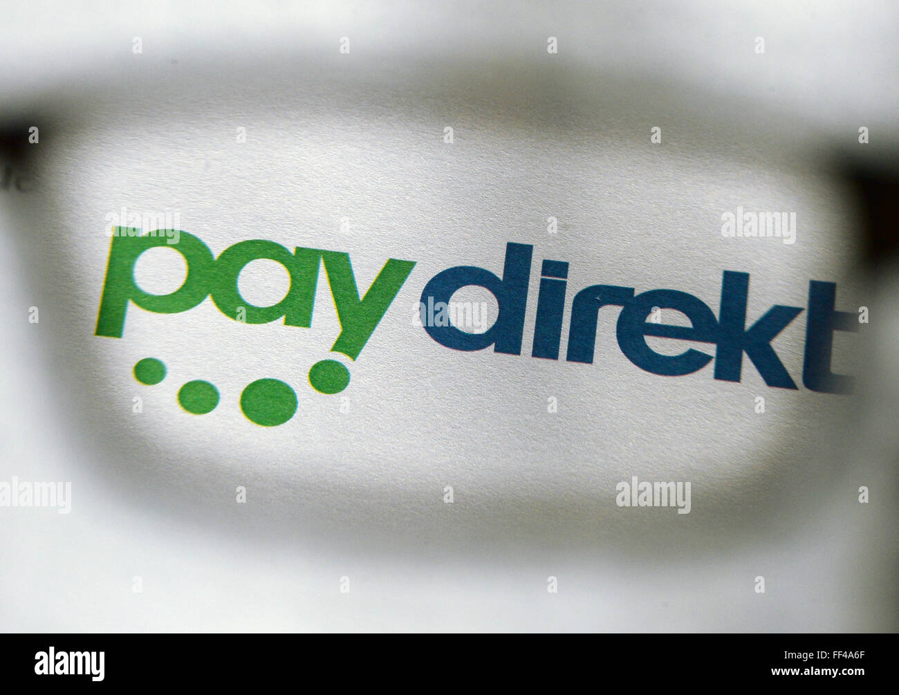 ILLUSTRATION - The logo of the online payment service Paydirekt photographed through a pair of glasses in Berlin, Germany, 03 February 2016. Paydirekt is a German company with a strict data protection policy that will not reroute funds to intermediary payment service providers. Payment transactions are included in regular account statements. Photo: JENS KALAENE/dpa Stock Photo