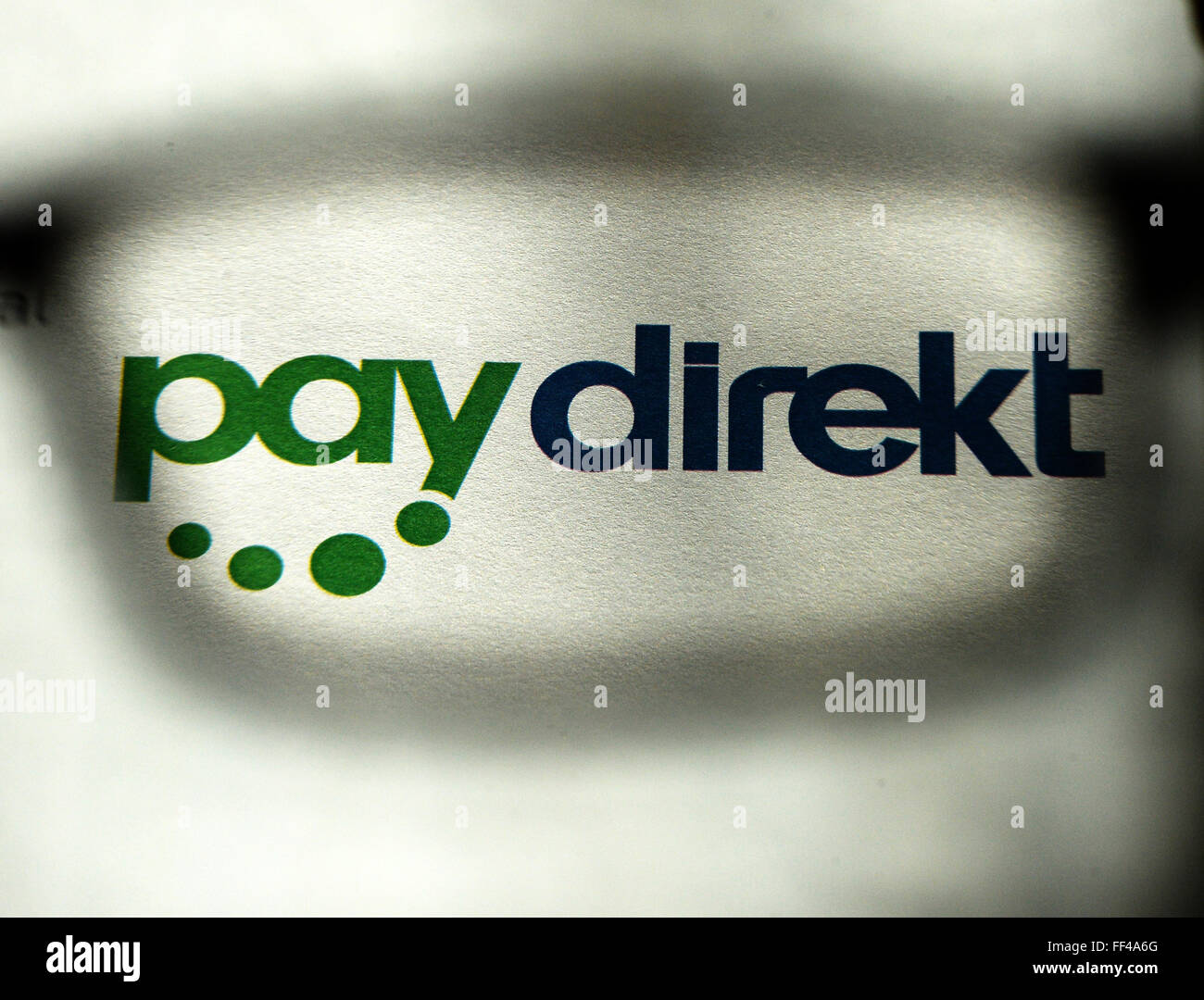 ILLUSTRATION - The logo of the online payment service Paydirekt shot through a pair of glasses in Berlin, Germany, 03 February 2016. Paydirekt is a German company with a strict data protection policy without rerouting funds to intermediary payment service providers. Payment transactions are included on regular account statements. Photo: JENS KALAENE/dpa Stock Photo