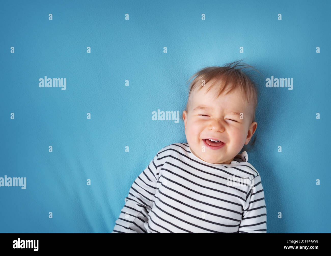 little boy on blue blanket background Stock Photo Alamy