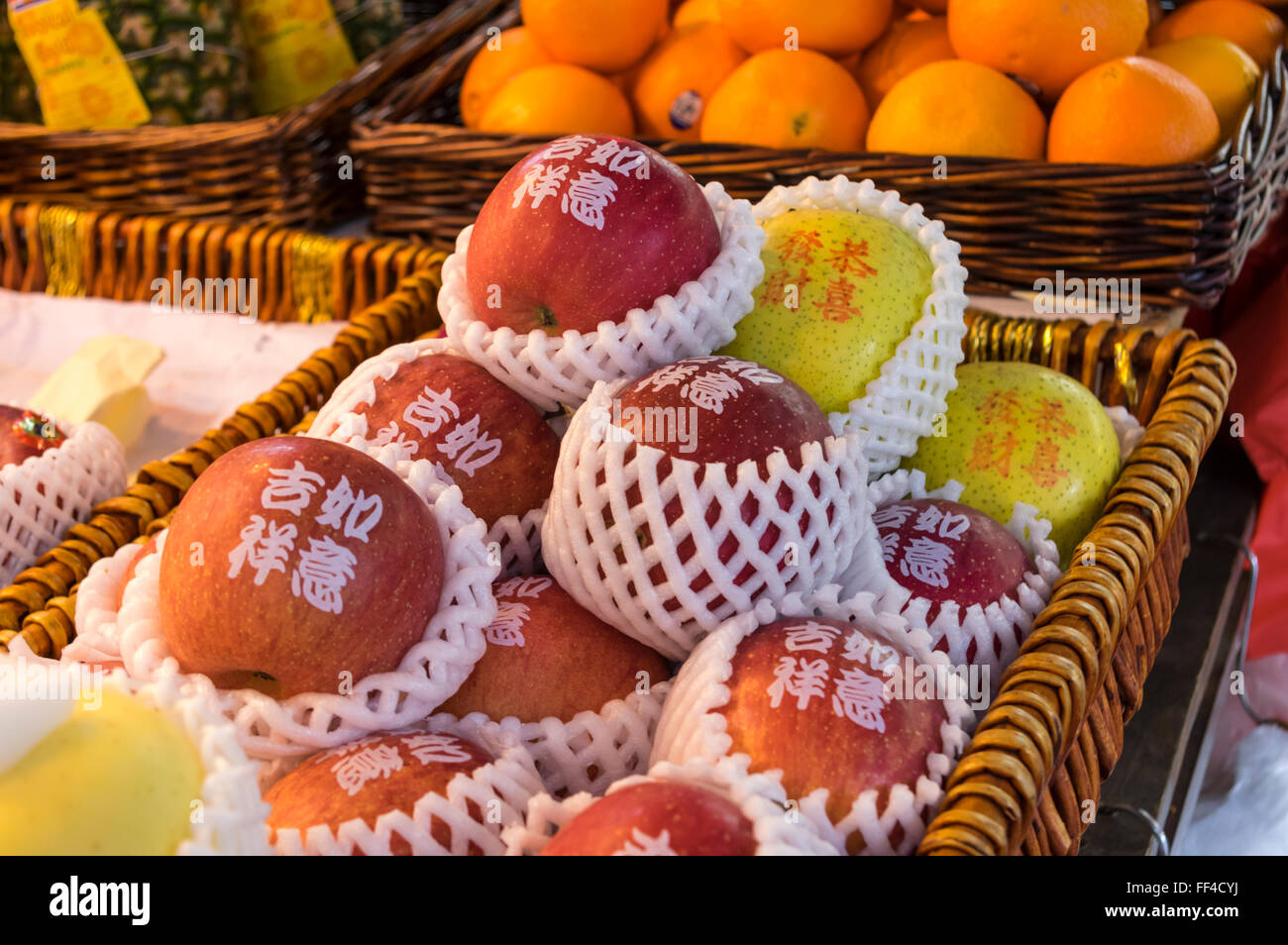 Individually foam-packaged and labeled apples on display on a food market in Hong Kong. Stock Photo
